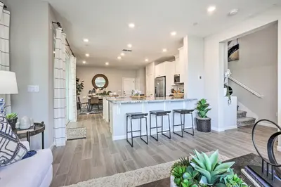 a kitchen and living room with a counter and stools at Relaxing Roseville Home with Outdoor Amenities in Roseville