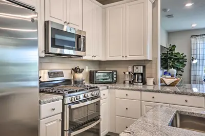 a kitchen with white cabinets and a stove top oven at Relaxing Roseville Home with Outdoor Amenities in Roseville