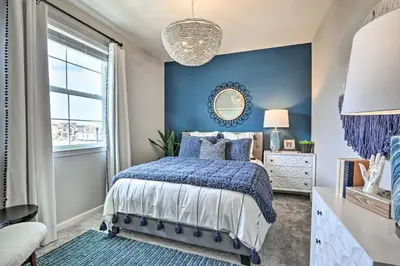 a blue bedroom with a bed and a mirror at Relaxing Roseville Home with Outdoor Amenities in Roseville