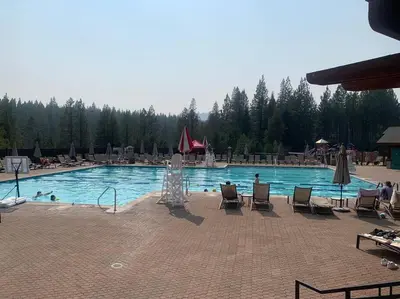 a large swimming pool with chairs and a fountain at Fully updated Truckee cabin with plenty of beds in Truckee