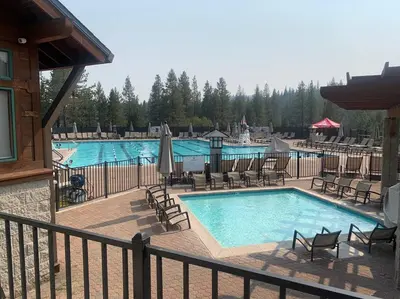 a large swimming pool with chairs and a pool at Fully updated Truckee cabin with plenty of beds in Truckee