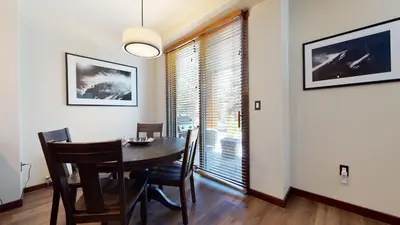 a dining room with a table and chairs and a window at Solstice #14 condo in Mammoth Lakes