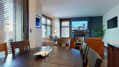 a dining room with a table and a living room at Solstice #14 condo in Mammoth Lakes