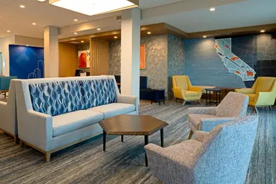 a waiting room with a couch and chairs at Holiday Inn Express & Suites - Hollister by IHG in Hollister