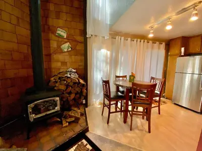 a dining room with a table and a fireplace at Mammoth Awesome Location-1 min to Shuttles & Food! TOML-CPAN-11402 in Mammoth Lakes