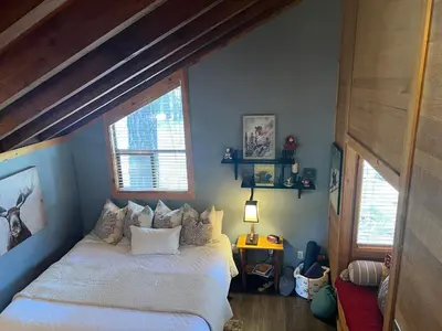 a bedroom with a bed and two windows at Indian Hills Gem Awaits in Truckee