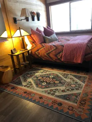 a bedroom with a bed with a rug on the floor at Indian Hills Gem Awaits in Truckee