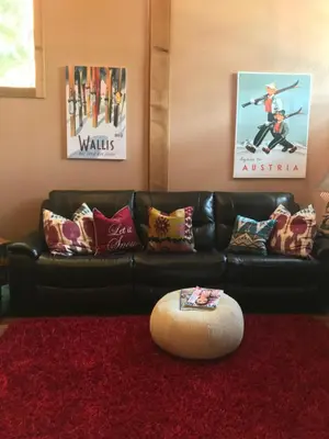 a living room with a black leather couch and a red rug at Indian Hills Gem Awaits in Truckee