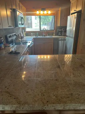 a kitchen with a granite counter top with a refrigerator at Indian Hills Gem Awaits in Truckee