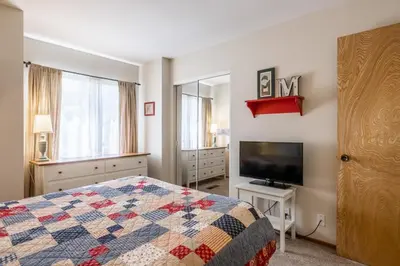 a bedroom with a bed and a flat screen tv at Snowcreek IV 549 in Mammoth Lakes
