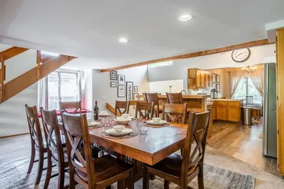 a kitchen and dining room with a wooden table and chairs at Snowcreek IV 549 in Mammoth Lakes