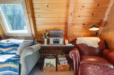 a room with a couch and a table and a chair at Decks, Grills and Fire Pit Camp Connell Hideaway! in Camp Connell