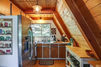 a kitchen with a refrigerator and a sink at Decks, Grills and Fire Pit Camp Connell Hideaway! in Camp Connell