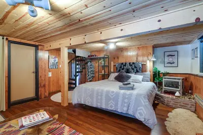 a bedroom with a bed and a fireplace at Decks, Grills and Fire Pit Camp Connell Hideaway! in Camp Connell