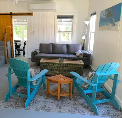 a living room with two chairs and a couch at Birdwatch Cottage With River Beach Pass in Three Rivers