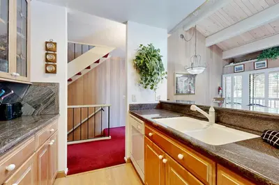a kitchen with a sink and a staircase at All-Season Getaway in Kings Beach