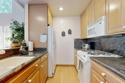 a kitchen with white appliances and wooden cabinets at All-Season Getaway in Kings Beach