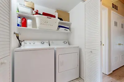 a white laundry room with a washer and dryer at All-Season Getaway in Kings Beach