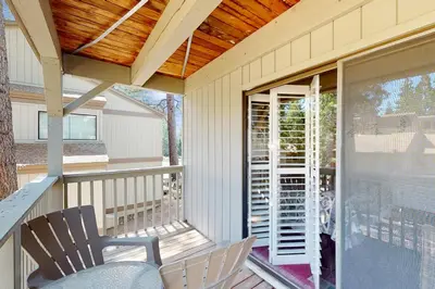 a screened in porch with a rocking chair and a table at All-Season Getaway in Kings Beach
