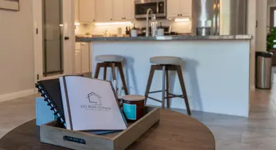 a laptop sitting on a table in a kitchen at Boho Townhome in Carson City 10 Mins From Downtown, 30 Mins To Lake Tahoe in Carson City