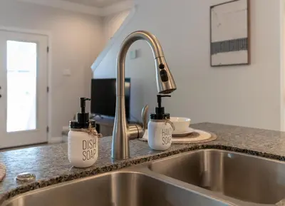 a kitchen sink with two bottles of dish soap at Boho Townhome in Carson City 10 Mins From Downtown, 30 Mins To Lake Tahoe in Carson City