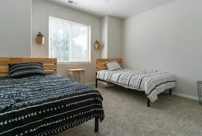 a bedroom with two beds and a window at Boho Townhome in Carson City 10 Mins From Downtown, 30 Mins To Lake Tahoe in Carson City