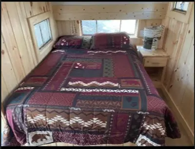 a bedroom with two beds in a log cabin at Glamping property in Panorama Heights
