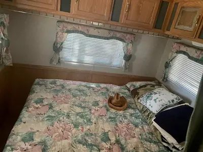 a bed in a small room with two windows at Glamping property in Panorama Heights