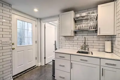 a kitchen with white cabinets and a sink at Ski and Hike Cozy Dtwn Reno Studio with Fireplace in Reno