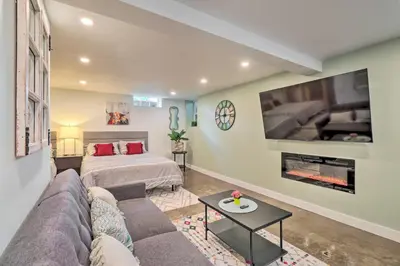 a living room with a couch and a bed and a tv at Ski and Hike Cozy Dtwn Reno Studio with Fireplace in Reno