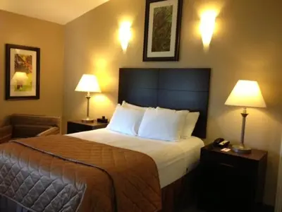 a hotel room with a bed and two lamps at Casa de Fruta Cabins, Inn & RV Park in Hollister