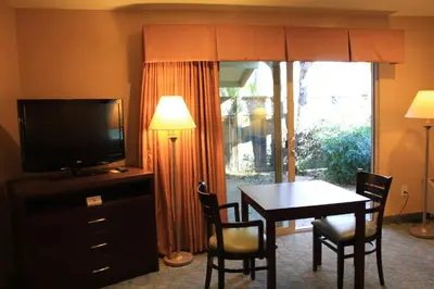 a living room with a dining room table and a television at Casa de Fruta Cabins, Inn & RV Park in Hollister