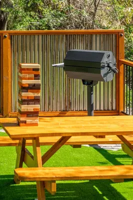 a grill on a picnic table in front of a fence at Casa de Fruta Cabins, Inn & RV Park in Hollister