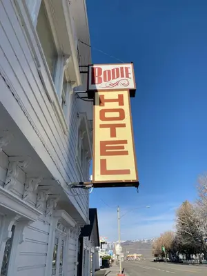 a sign on the side of a building with a hotel sign at The Bodie Hotel in Bridgeport