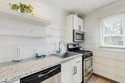 a white kitchen with a sink and a stove at Manzanita Holiday 3 in South Lake Tahoe