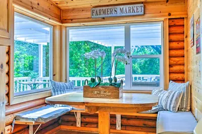 a dining room with a table and a window at Steps to Dtwn Murphys Cottage with Furnished Porch in Murphys