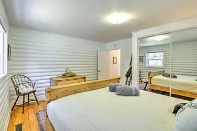 a bedroom with two beds and a mirror at Steps to Dtwn Murphys Cottage with Furnished Porch in Murphys