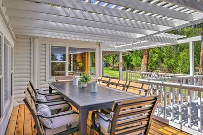 a patio with a table and chairs on a deck at Steps to Dtwn Murphys Cottage with Furnished Porch in Murphys