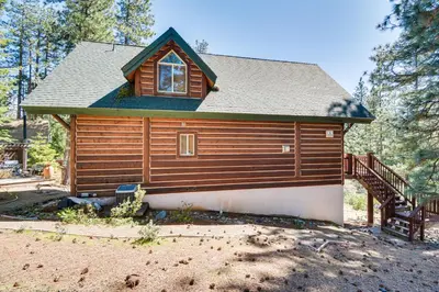 a log cabin with a staircase in front of it at 2 Cabins Group and Family Getaway in Arnold! in Arnold