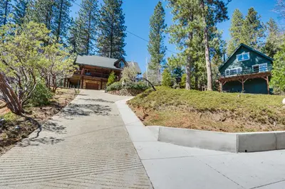 a walkway leading to a house with a log at 2 Cabins Group and Family Getaway in Arnold! in Arnold