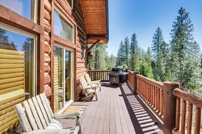 a deck with chairs and a grill on a house at 2 Cabins Group and Family Getaway in Arnold! in Arnold