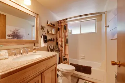 a bathroom with a toilet and a sink and a shower at Furnished Deck High Sierra Cabin in Twain Harte! in Twain Harte