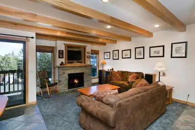 a living room with a couch and a fireplace at Val D'Isere at the Village by 101 Great Escapes in Mammoth Lakes