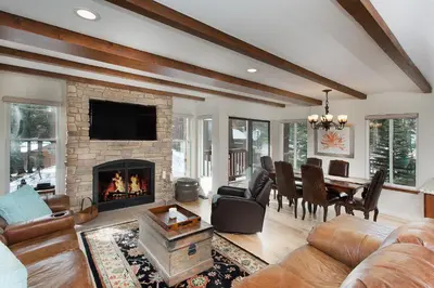 a living room with a fireplace and a dining room at Val D'Isere at the Village by 101 Great Escapes in Mammoth Lakes
