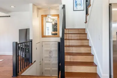a staircase in a home with white walls and wood floors at Chamonix 24 is a 2bed plus loft 3 bath Upgraded Canyon Ldge Nearly Ski in Ski Out Sleeps 8 in Mammoth Lakes