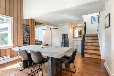 a kitchen and dining room with a large table and chairs at Chamonix 24 is a 2bed plus loft 3 bath Upgraded Canyon Ldge Nearly Ski in Ski Out Sleeps 8 in Mammoth Lakes