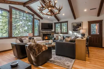 a living room filled with furniture and a chandelier at Gray Bear #86 home in Mammoth Lakes