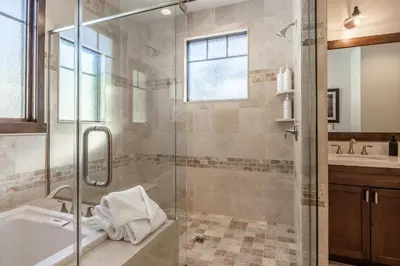 a bathroom with a shower and a tub and a sink at Gray Bear #86 home in Mammoth Lakes