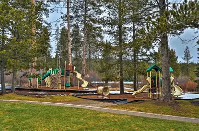 a playground in a park with a slide at Wraparound Deck and Pool Access Truckee Cabin in Truckee