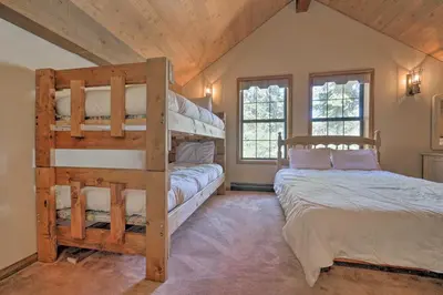 a bedroom with two bunk beds in a attic at Wraparound Deck and Pool Access Truckee Cabin in Truckee